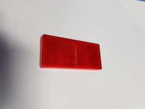 ODBLASK ASPOCK CZERWONY KLEJ 69X31,5MM